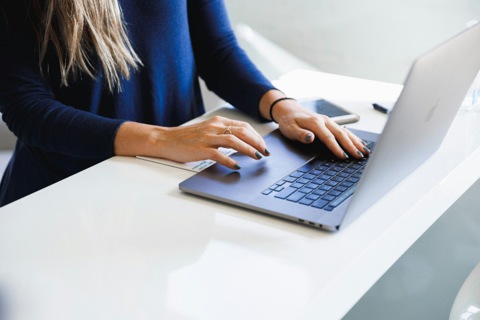 close up of a woman using a laptop
